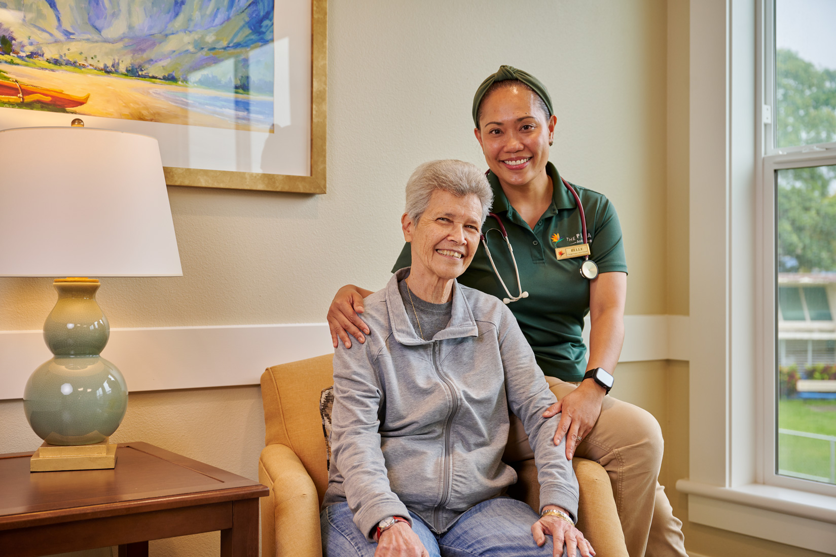Clinical staff member smiling with a resident at The Plaza Assisted Living.