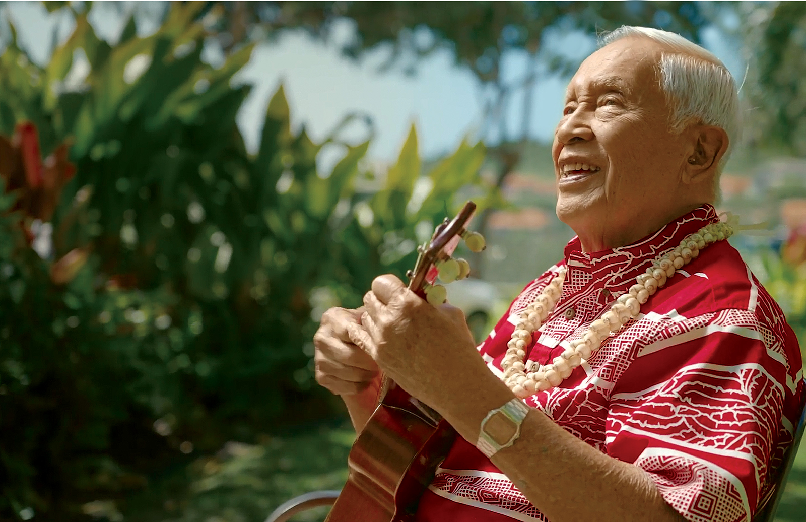 Resident playing ukulele at The Plaza Assisted Living open house.