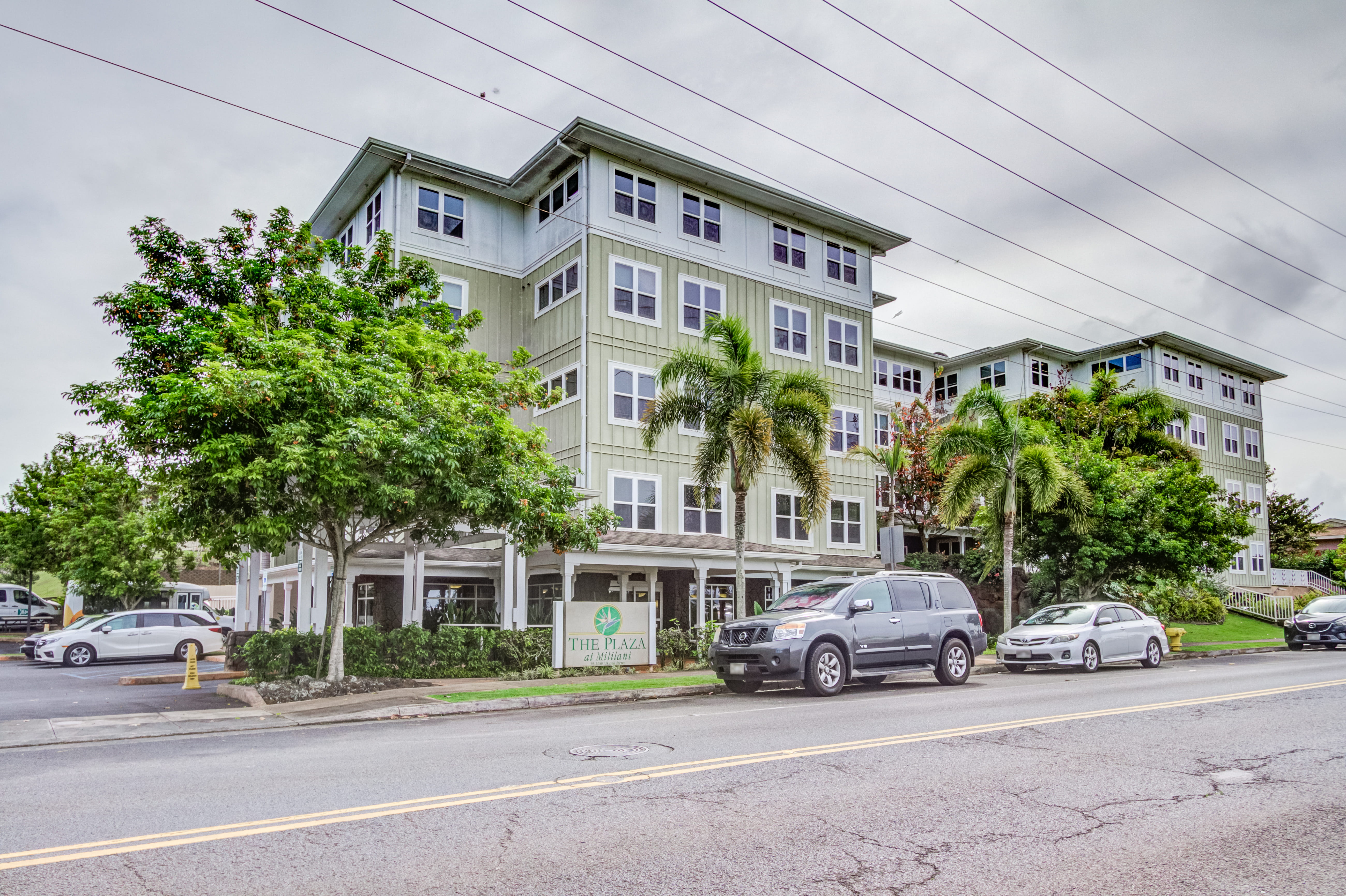 Street-level view of the multi-story The Plaza at Mililani building.