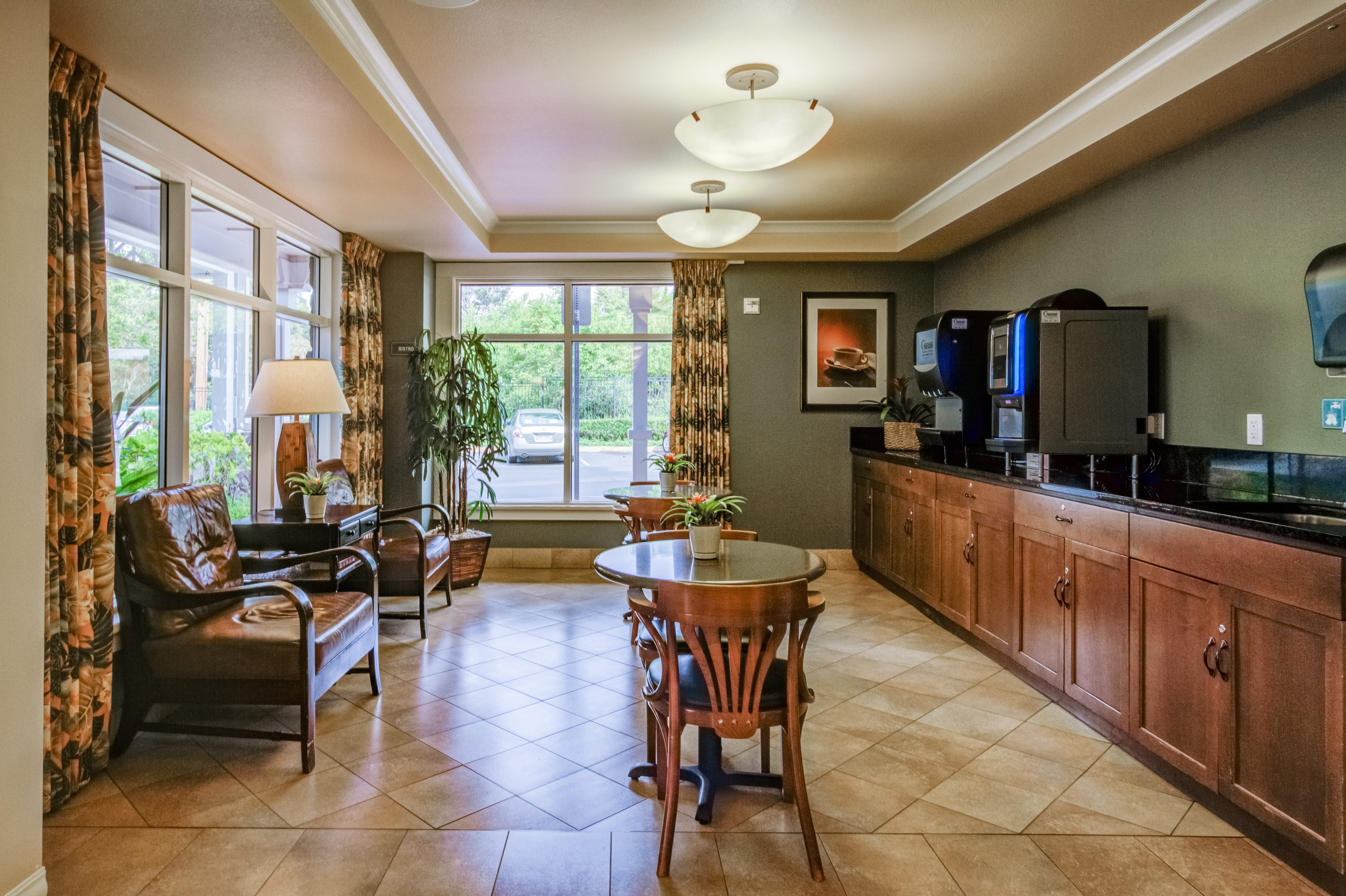 Bistro area with coffee service and seating at The Plaza Assisted Living Mililani.