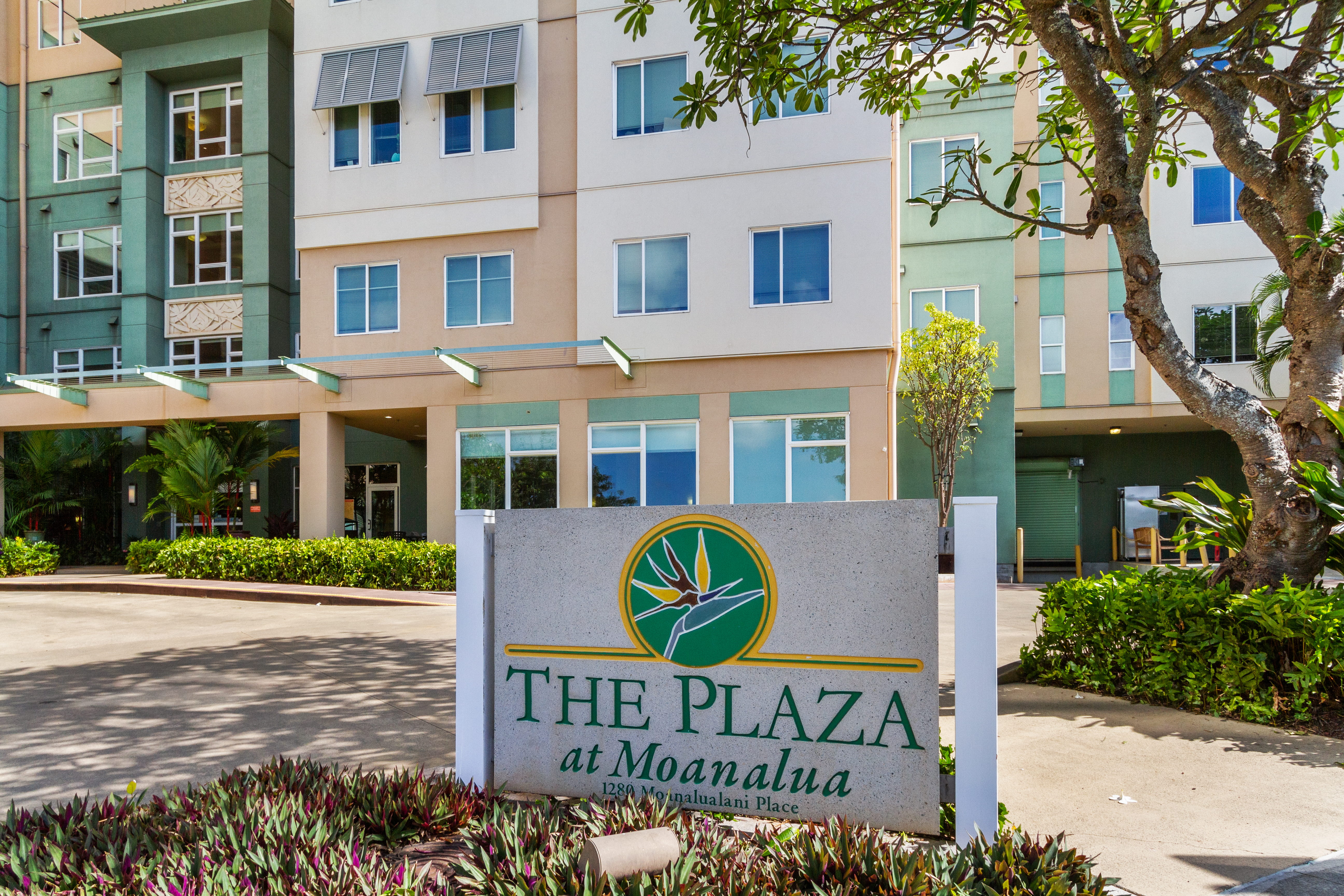 Entrance sign for The Plaza at Moanalua in front of the community building.
