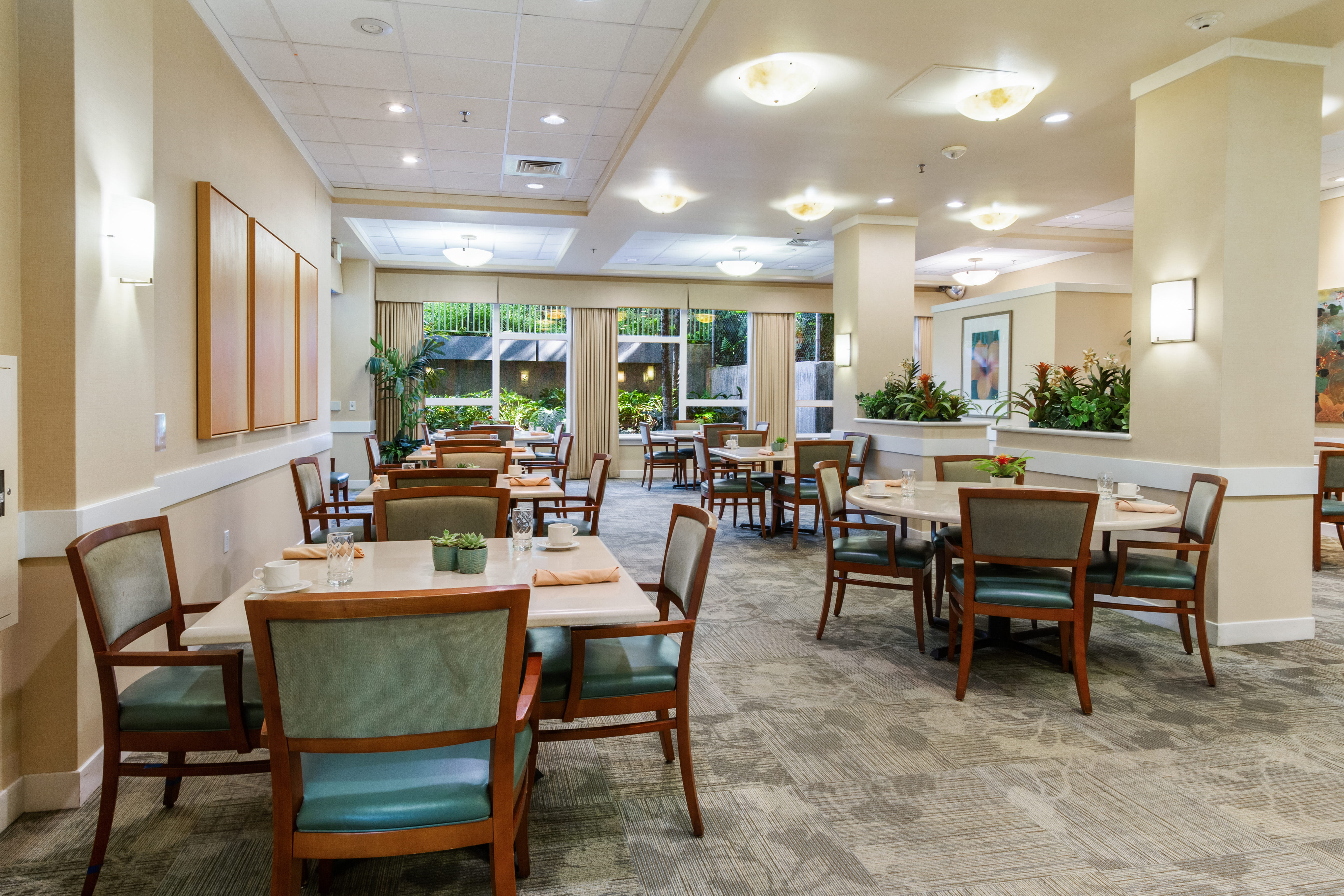 Spacious communal dining room with elegant tables and chairs.