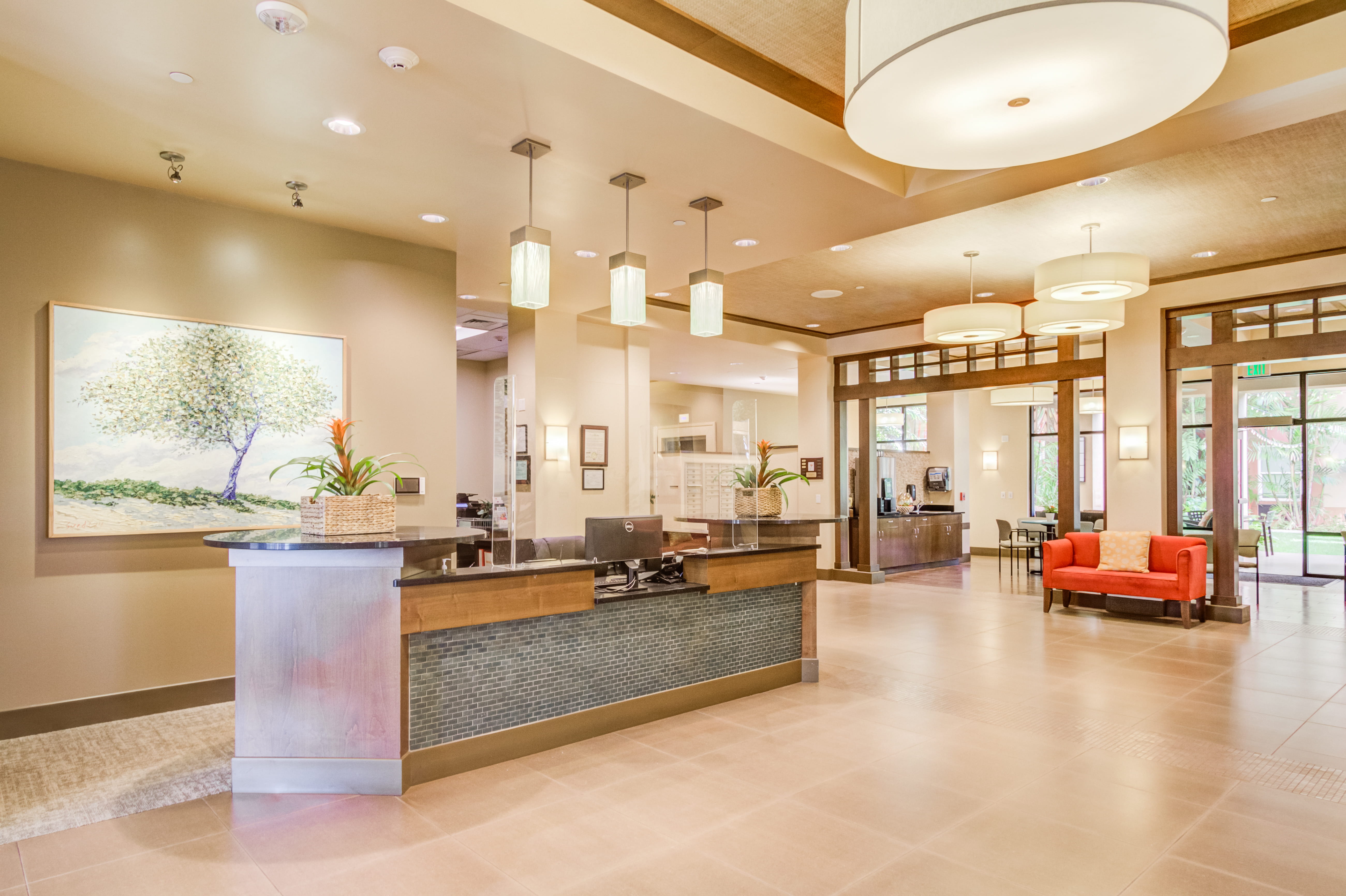 Reception desk at The Plaza Assisted Living Pearl City lobby area.
