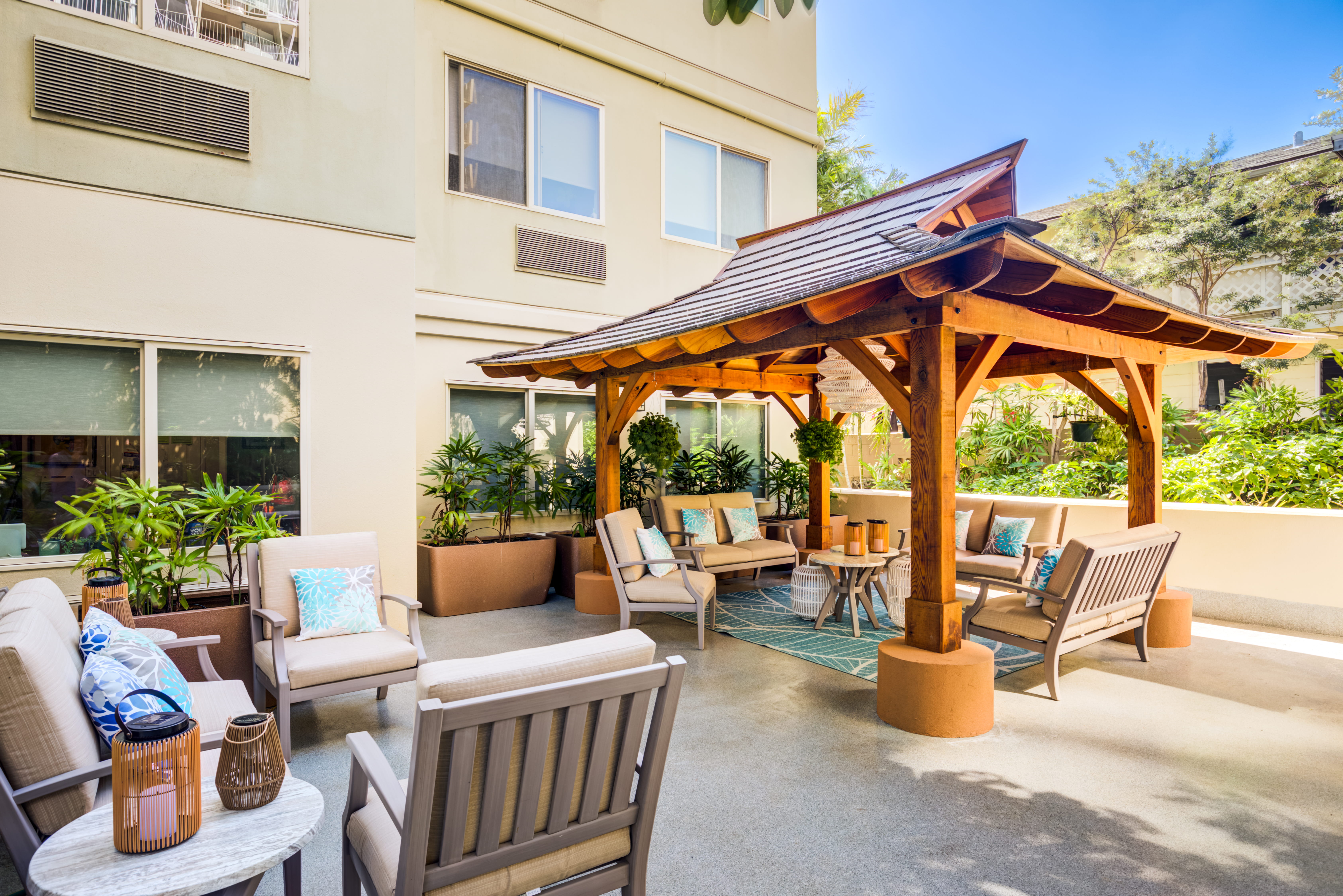 Outdoor patio with a wooden gazebo and comfortable lounge seating.