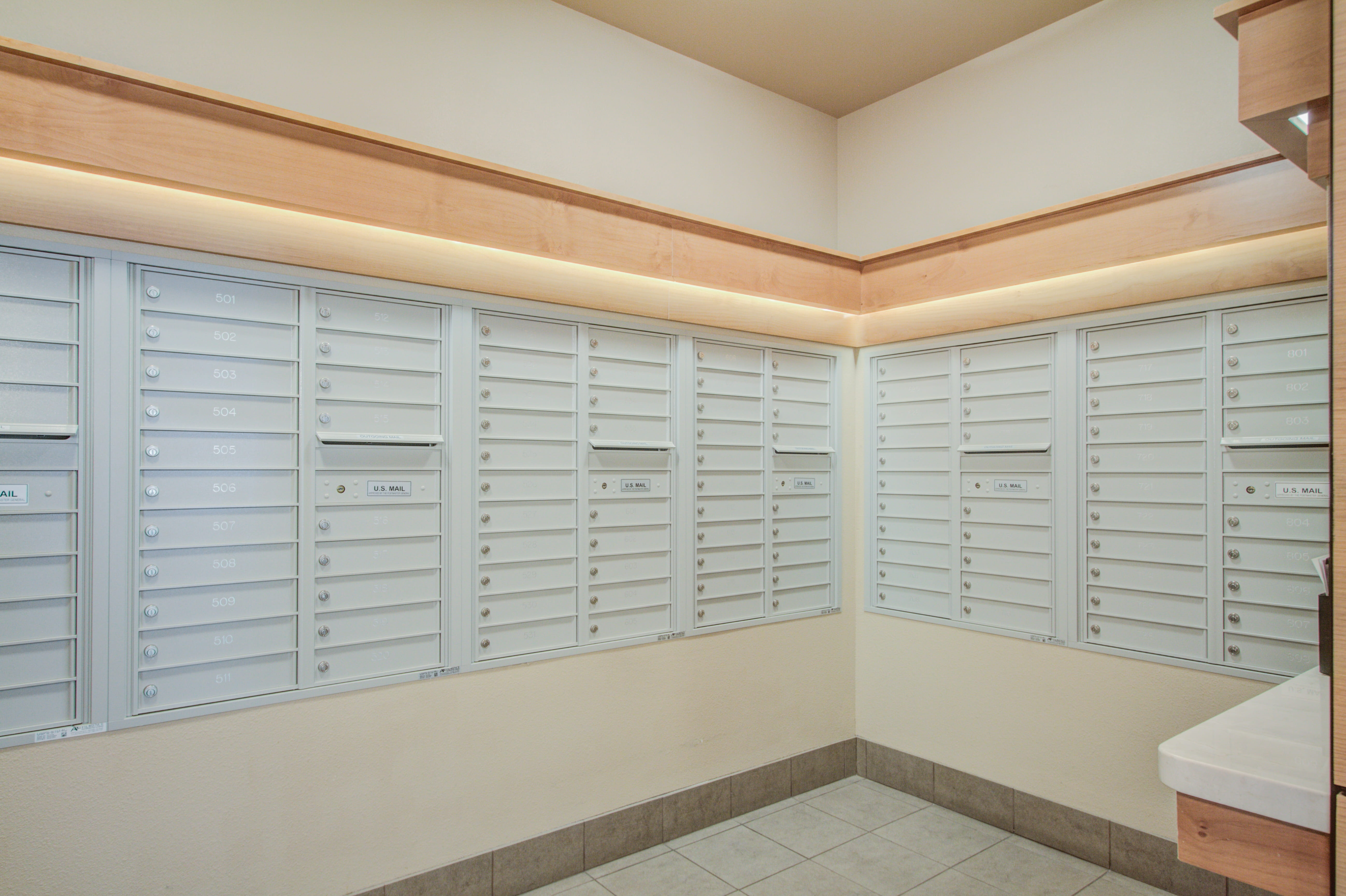 Bright resident mailbox area in a modern corridor at The Plaza at Waikiki.