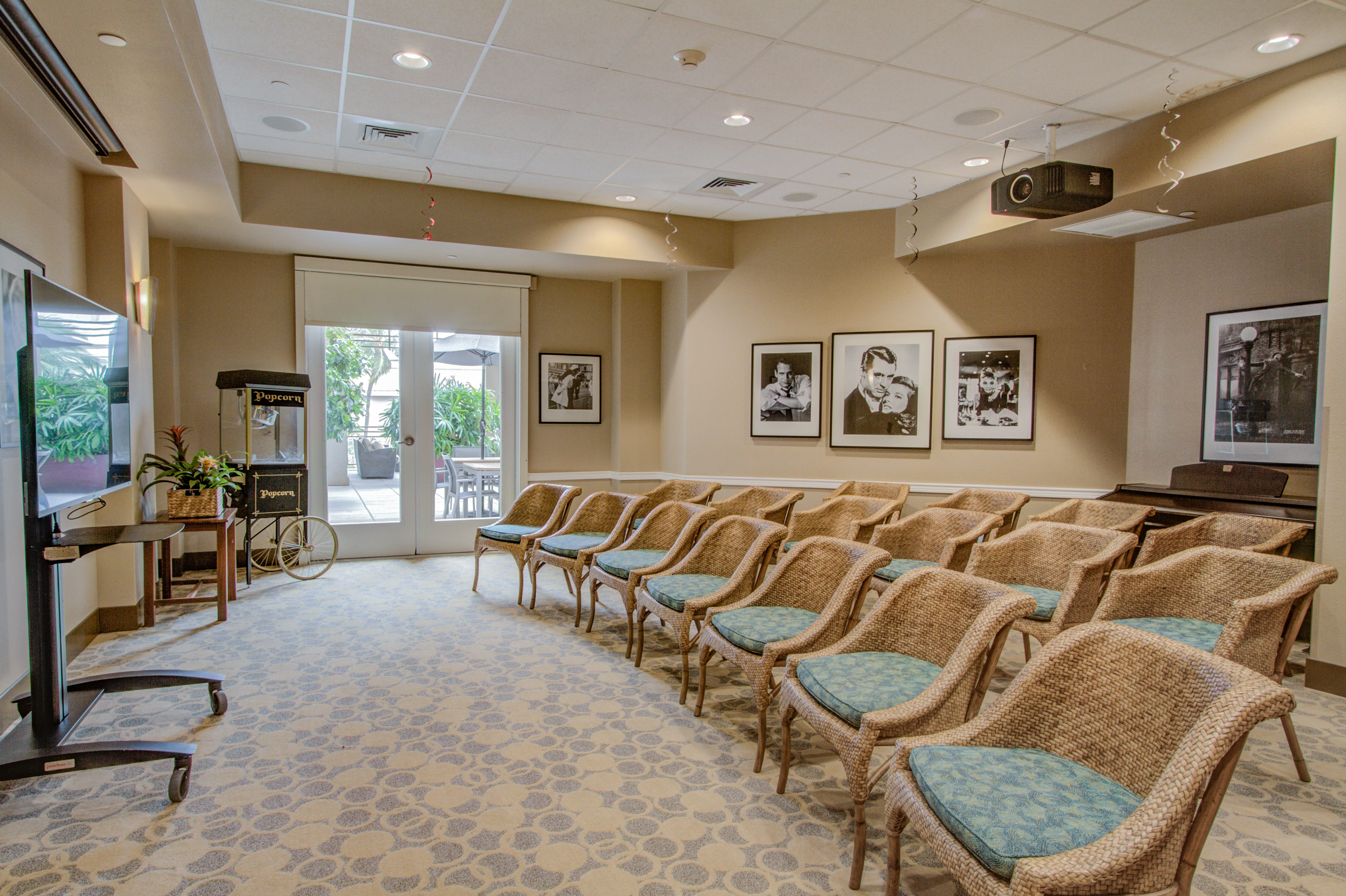 Movie theater room with wicker chairs and a popcorn machine at Waikiki.