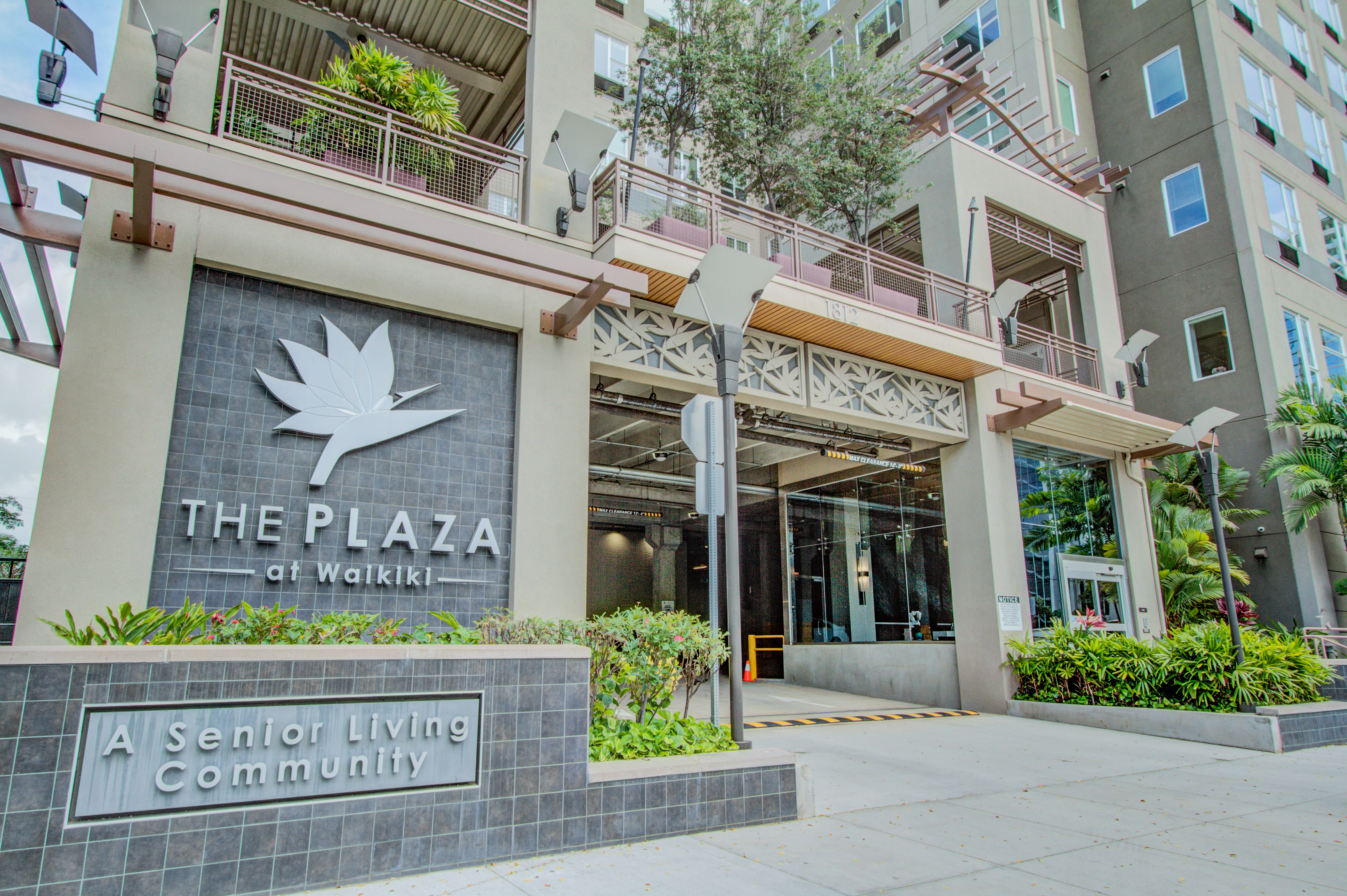 Exterior entrance sign for The Plaza at Waikiki senior living community.
