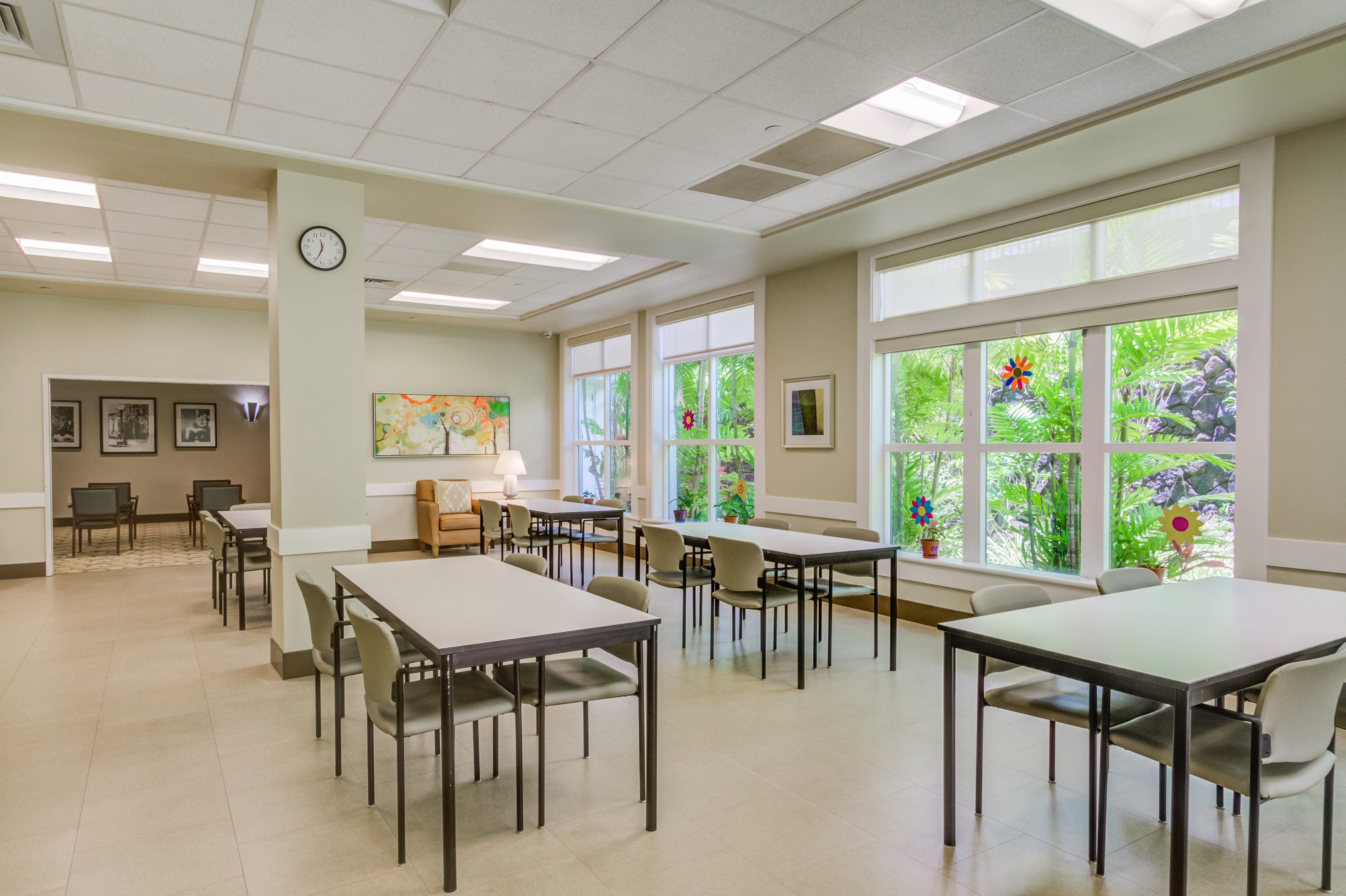 Bright communal dining and activity area with large windows.
