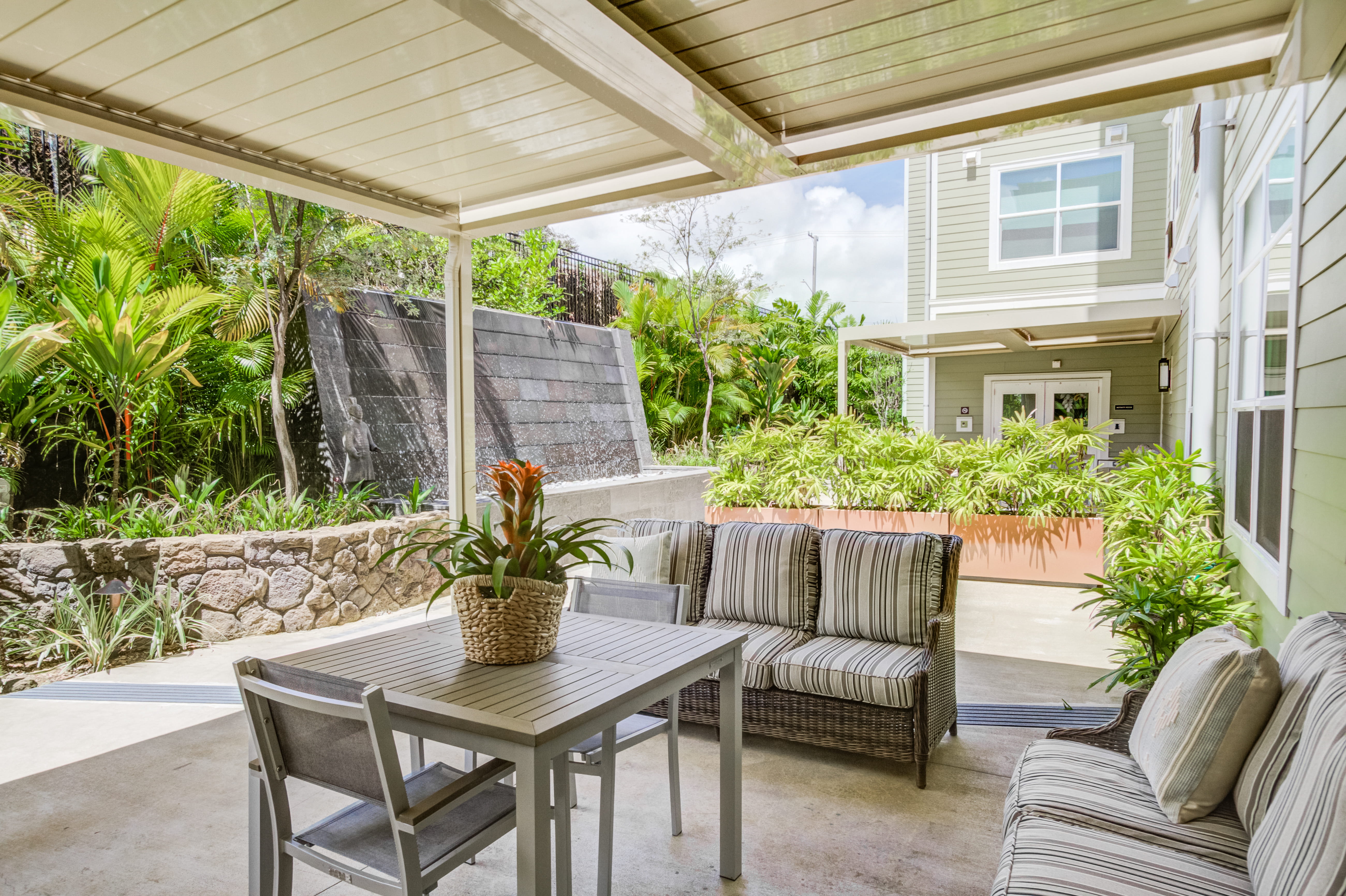 Comfortable outdoor patio with a seating area and water feature.