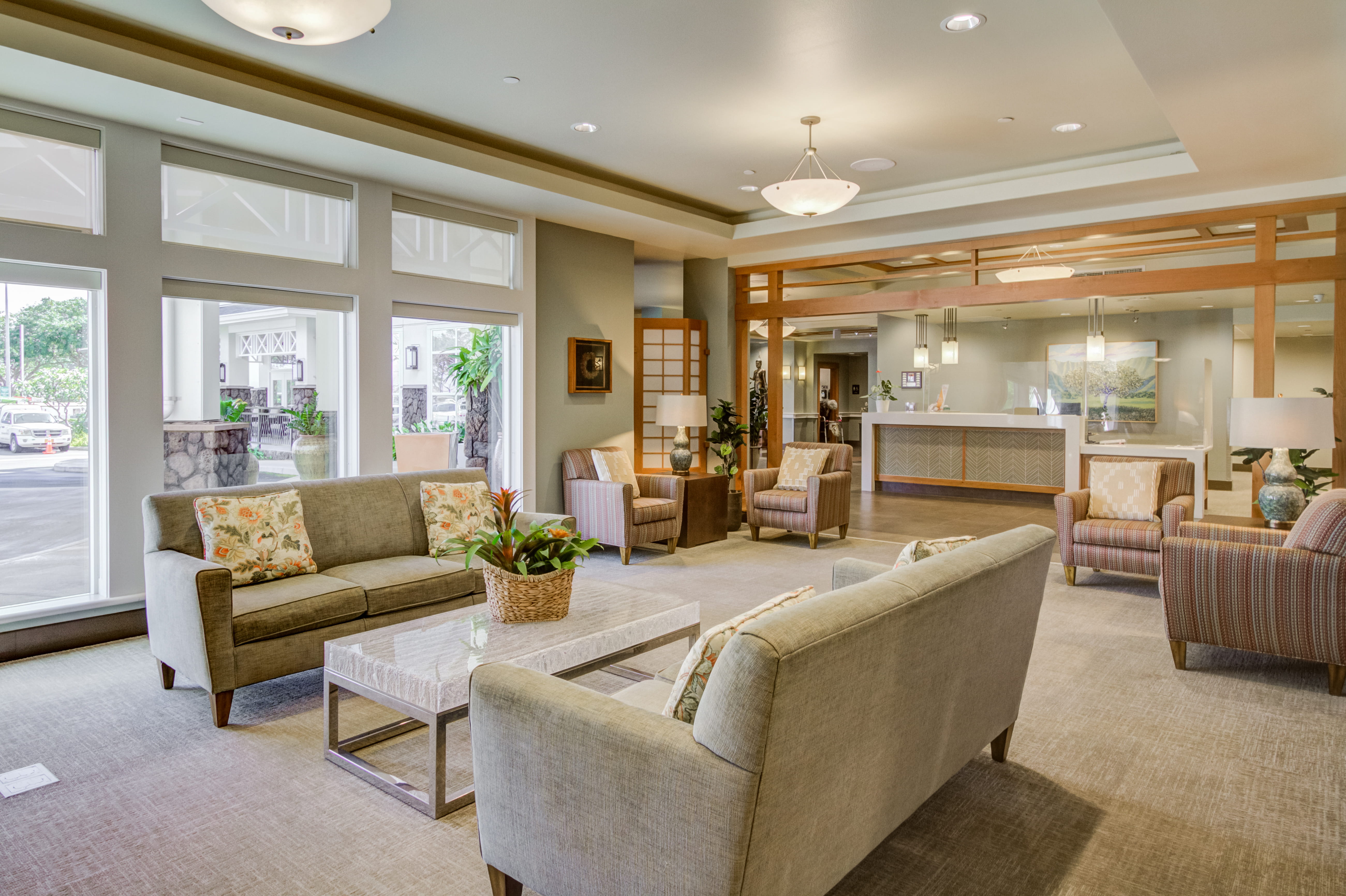 Sunlit lobby lounge with comfortable seating at The Plaza Assisted Living.