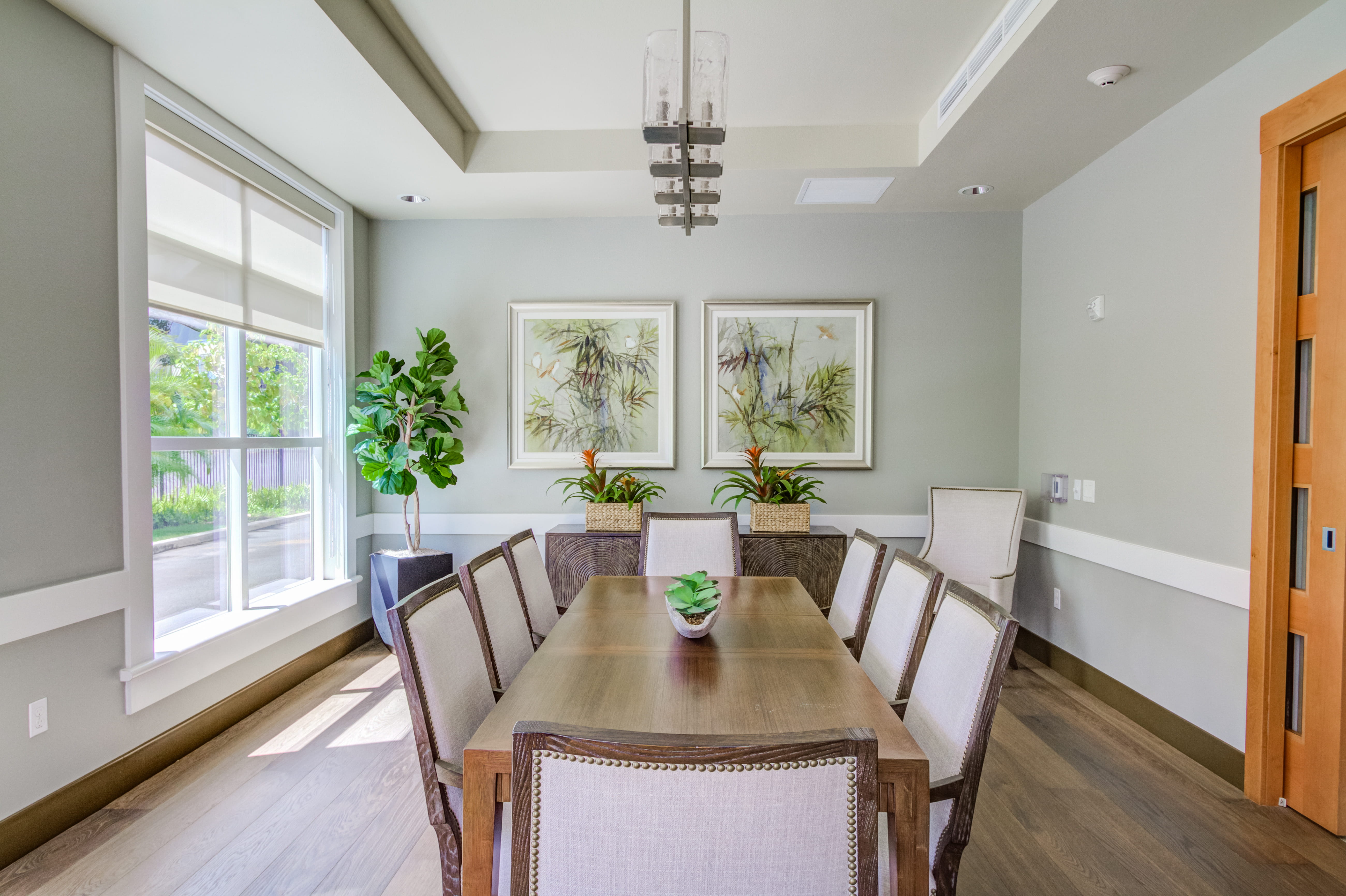 Elegant private dining room with a long table and large windows.