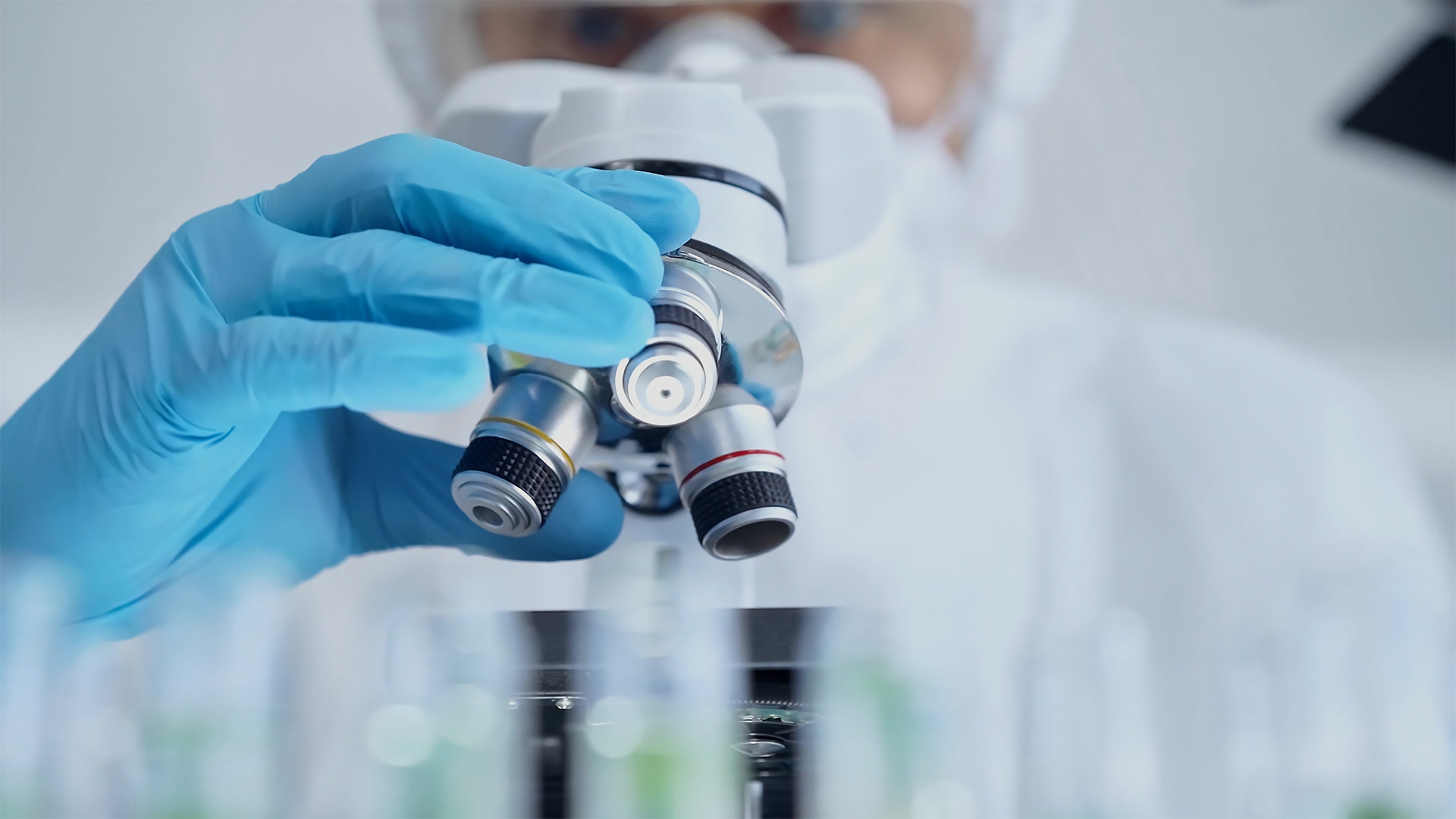 Professional using a microscope to ensure health standards at The Plaza Assisted Living.