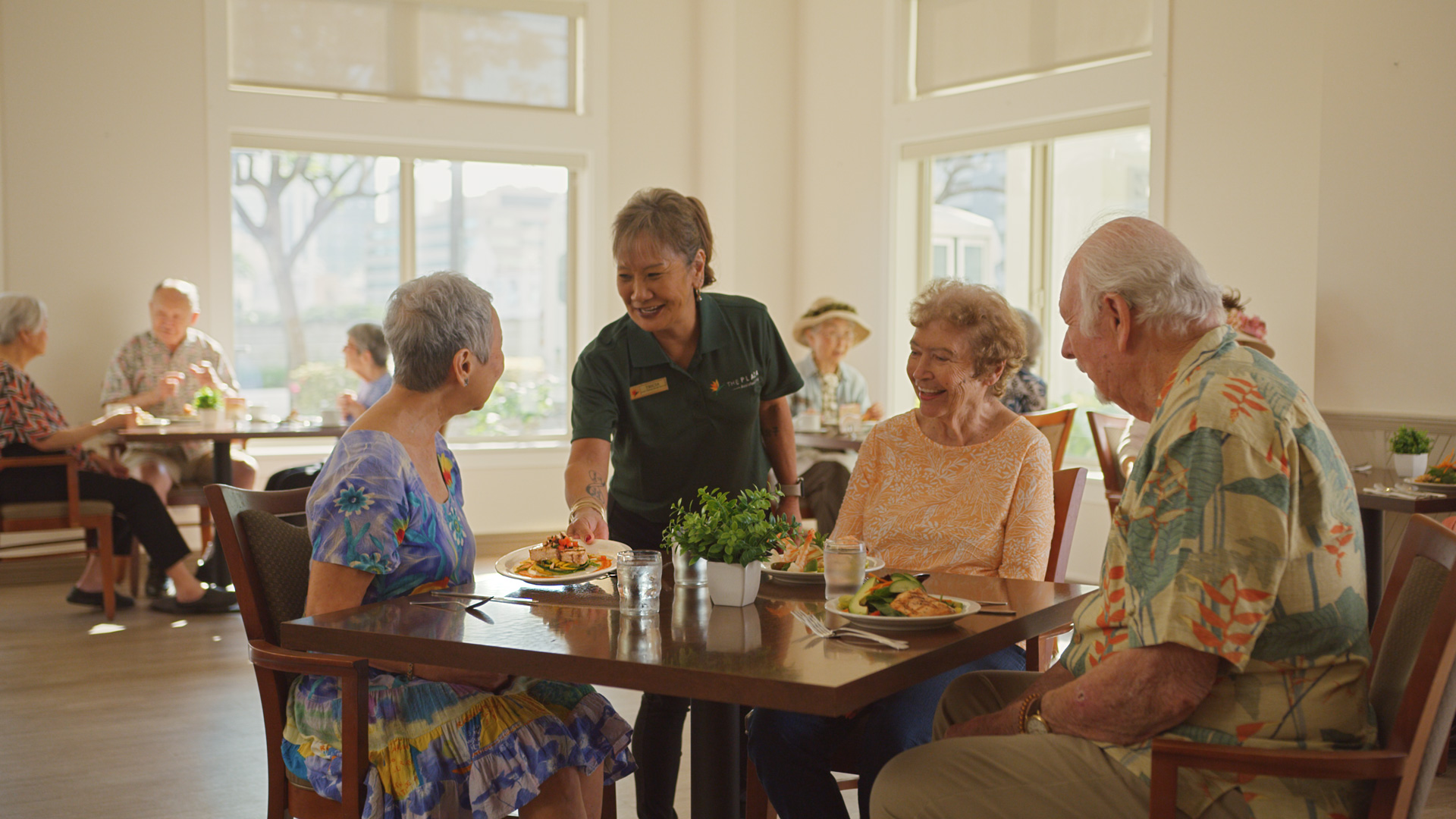 Staff member serving a gourmet meal to residents at The Plaza Assisted Living.