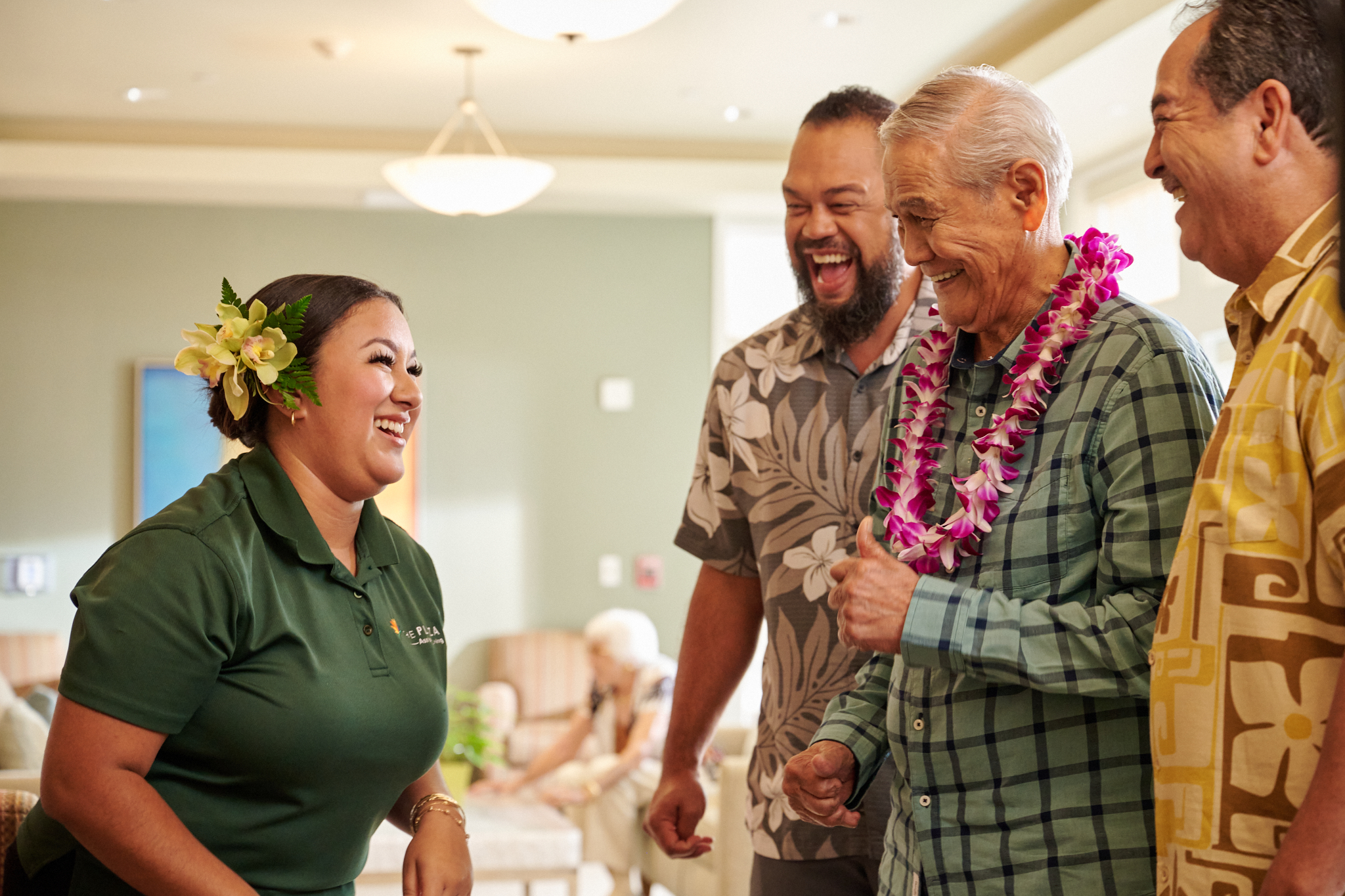 Residents and staff laughing together at The Plaza Assisted Living.